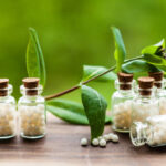 Classical Homeopathy globules in vintage bottles and nature leaves